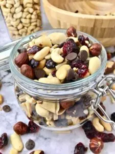 trail mix of nuts chocolate chips and dried fruit in jar