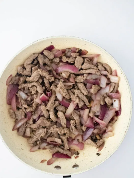 steak onions and mushrooms in skillet