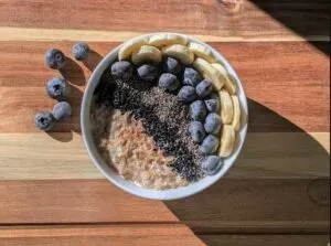 gluten free low fodmap chia pudding topped with blueberries on wood