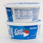 two tubs of cool whip stacked with white background