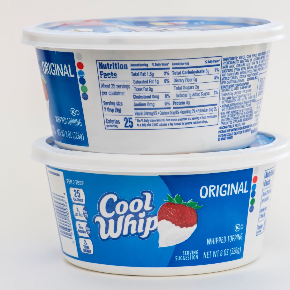 two tubs of cool whip stacked with white background