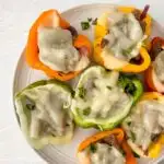 image of prepared philly cheesesteak stuffed peppers on white plate