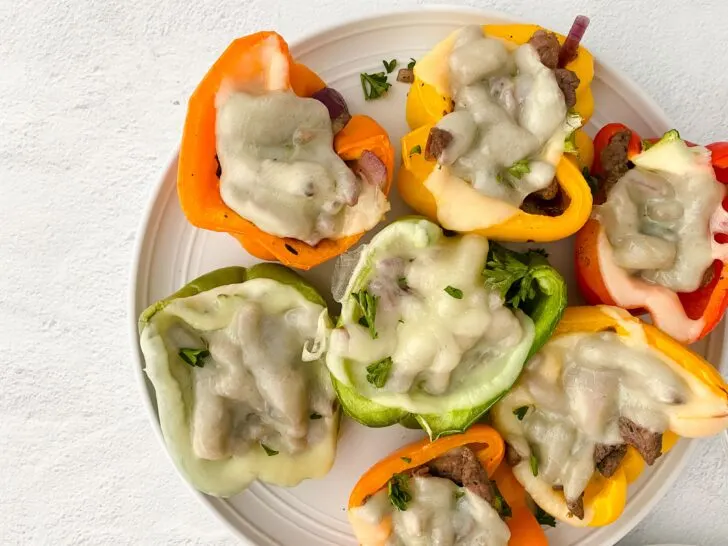 image of prepared philly cheesesteak stuffed peppers on white plate