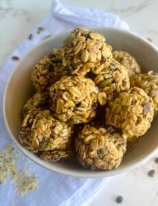 gluten free vegan no bake energy balls made with oats in white bowl