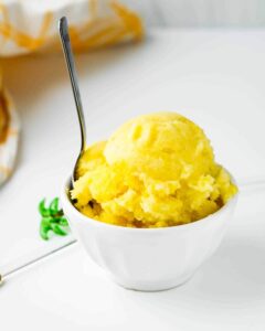 bowl of homemade pineapple sorbet with spoon