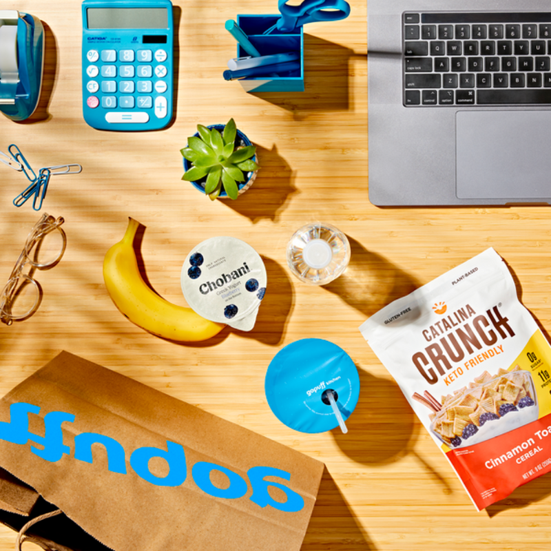 go puff paper bag with grocery essentials on desk