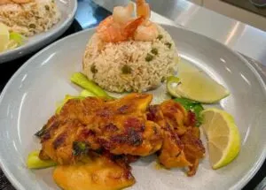 vietnamese style grilled chicken on plate with rice and lime