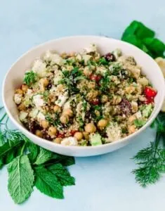 greek quinoa salad in bowl with chickpeas