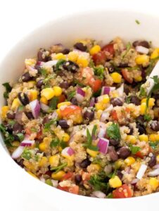 black bean quinoa salad with onion corn and tomatoes in bowl