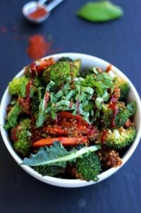 vegan quinoa fried rice topped with broccoli and peppers