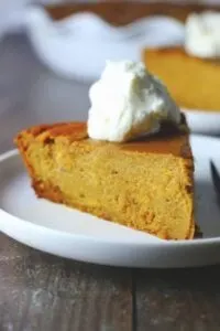 gluten free impossible pumpkin pie topped with whipped cream