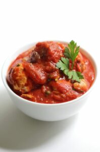 low carb italian chicken meatballs in white bowl with parsley