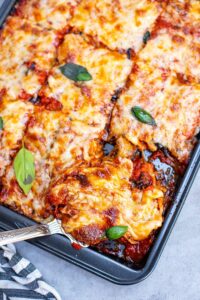 low carb baked italian eggplant in black casserole dish