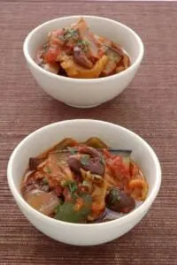 caponata in white bowls on brown surface