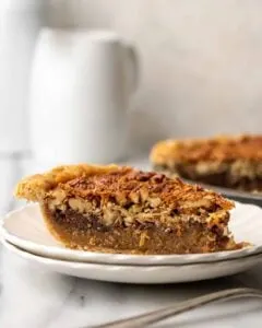 slice of gluten free german chocolate pecan pie on white plate