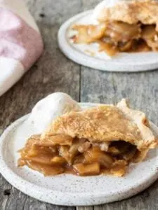 gluten free apple pie slice on plate with scoop of vanilla ice cream
