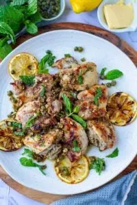 keto grilled chicken picata recipe on white stone plate on brown cutting board
