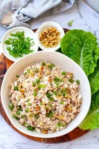 keto chicken salad with mushrooms and mayo in white bowl with lettuce leaves