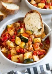 ratatouille in stone bowl with slice of gluten free bread
