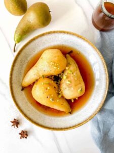spiced poached pears in stoneware bowl