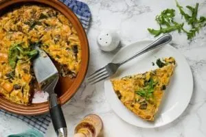 tuna mushroom egg bake in pan with slice on plate