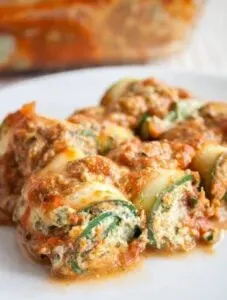 gluten free vegan zucchini lasagna roll ups on white plate