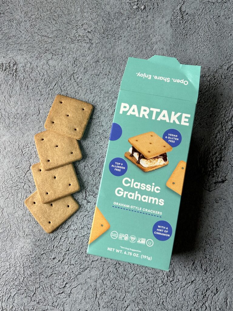 box of partake class grahams top 9 allergen free graham crackers on concrete with four crackers next to the box