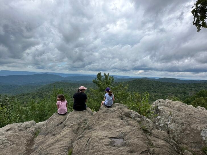 Sharon McCaskill, RDN, and her children sitting on a rock at shenandoah national park
