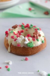 gluten free christmas mochi donut with frosting and sprinkles