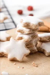frosted gluten free cinnamon star cookies on wood