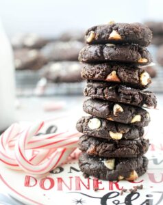 stack of paleo peppermint chocolate cookies on christmas plate with candy canes