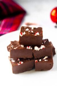 gluten free vegan peppermint fudge topped with candy canes on white plate
