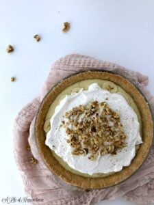 gluten free dairy free banana cream pie topped with walnuts on pin towel