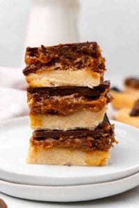 dairy free gluten free millionaire shortbread bars stacked on white plate