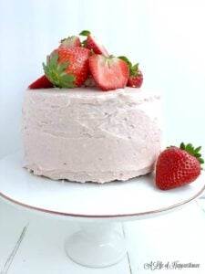 dairy free gluten free strawberry almond flour cake on white cake stand