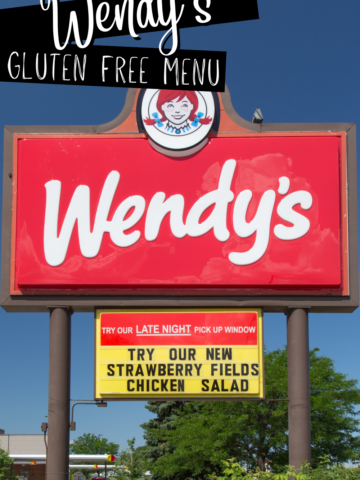 A photo of a Wendy's drive-thru road sign with text overlay that says 'Wendy's Gluten Free Menu'