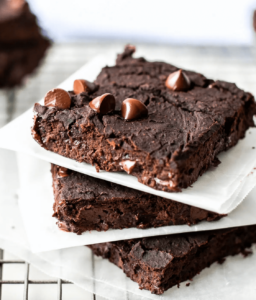 gluten free vegan black bean brownies stacked with parchment