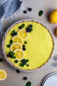 gluten free vegan lemon pie topped with blueberries and lemon slices