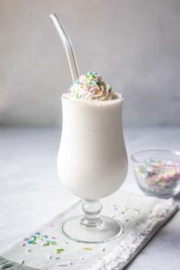 gluten free vegan milkshake topped with sprinkles in class with straw