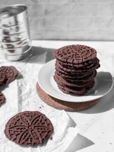 dairy free gluten free chocolate pizzelle cookies stacked on white plate