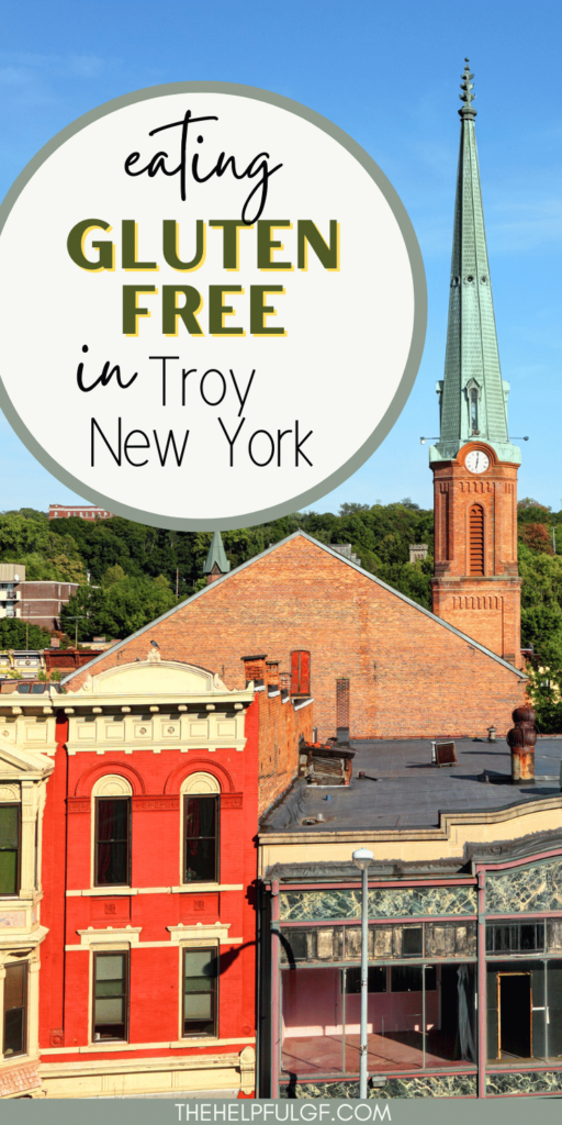 A church steeple sits in the background of the photo and in the foreground are historic looking buildings with the text overlay Eating Gluten Free in Troy New York