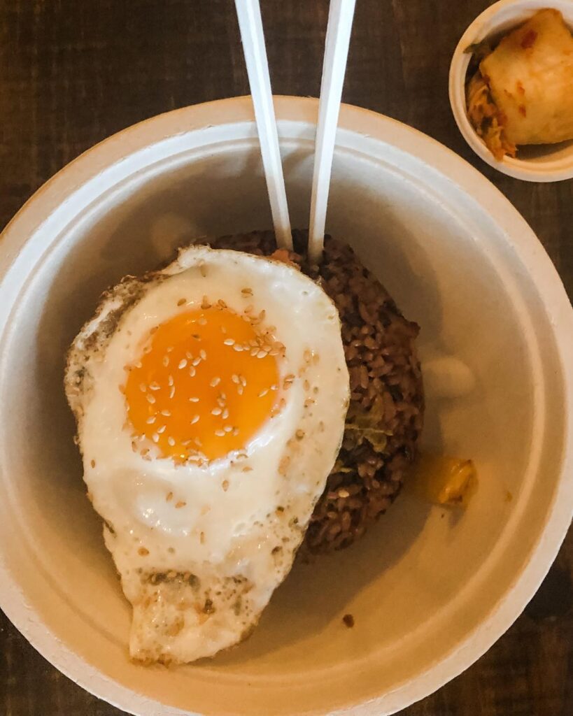 A bowl of gluten free fried rice topped with a full egg from Sunhee's restaurant. 