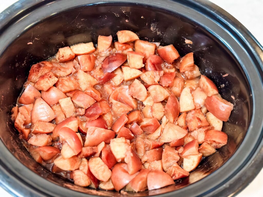 cooked apples in slow cooker ready to be blending into applesauce