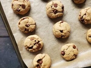 dairy free gluten free chocolate chip cookies on baking sheet with parchment