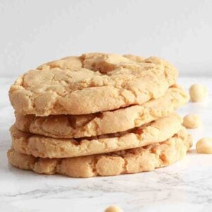 dairy free gluten free macadamia cookies stacked on marble counter