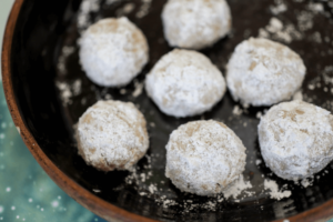 gluten free dairy free mexican wedding cookies on black plate