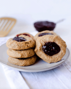 gluten free dairy free peanut butter jelly thumbprint cookies on grey plate