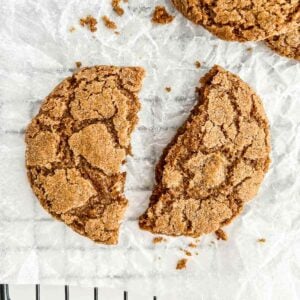 gluten free vegan gingersnap cookie broken in half on parchment