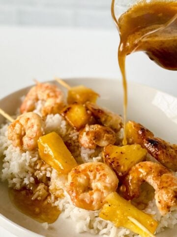 paleo honey garlic shrimp and pineapple skewers over rice