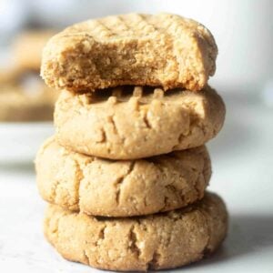 stack of almond flour peanut butter cookies, the top one with a bite out of it